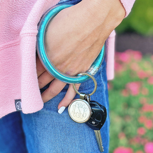 aqua monogrammed confetti key ring around hand
