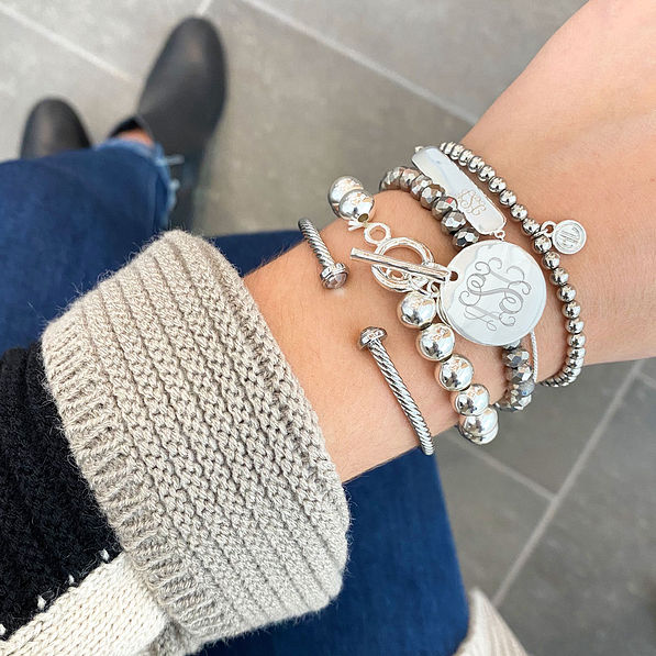 silver monogrammed ball bracelet with cardigan and booties