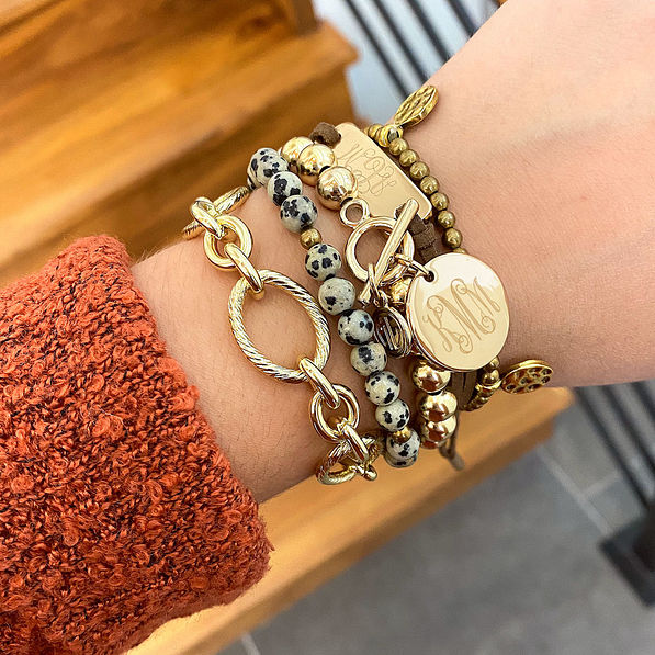 gold monogrammed ball bracelet with rust boyfriend sweater