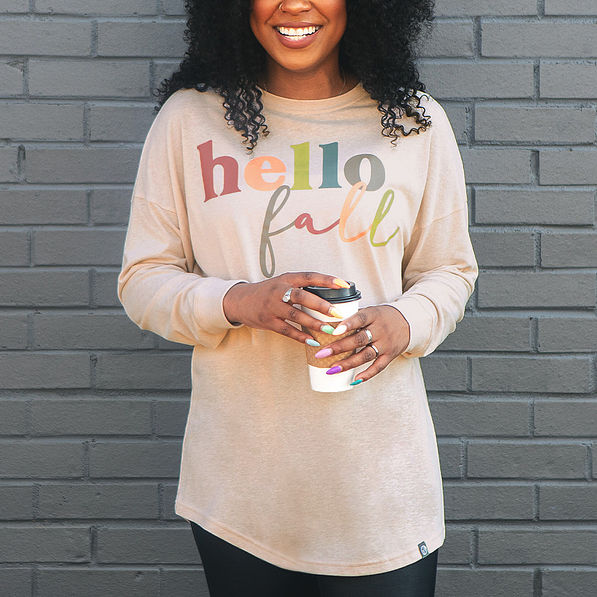 hello fall graphic on t-shirt with coffee in hands
