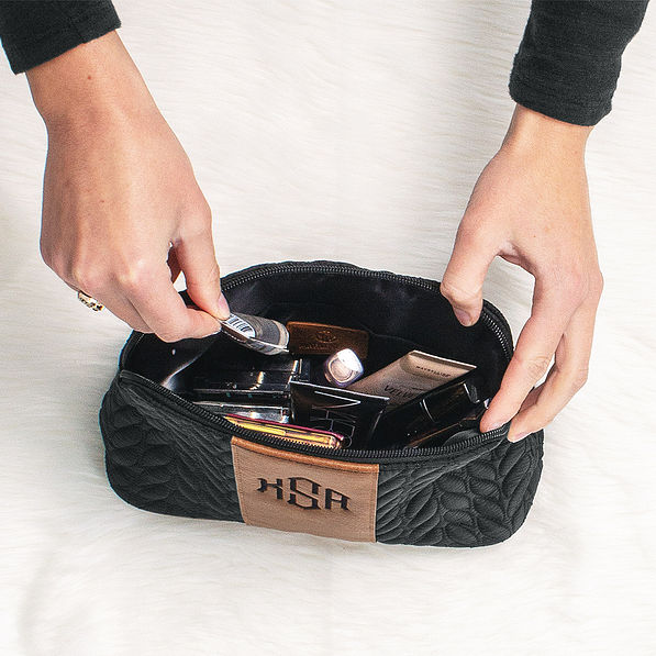 inside of black and brown quilted travel makeup bag