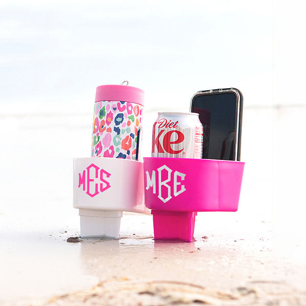 sand buddy in white and hot pink holding things