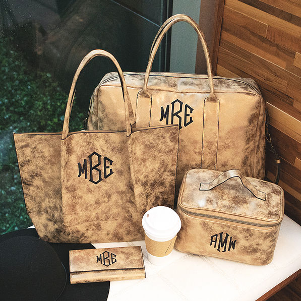 monogrammed distressed metallic travel bag collection