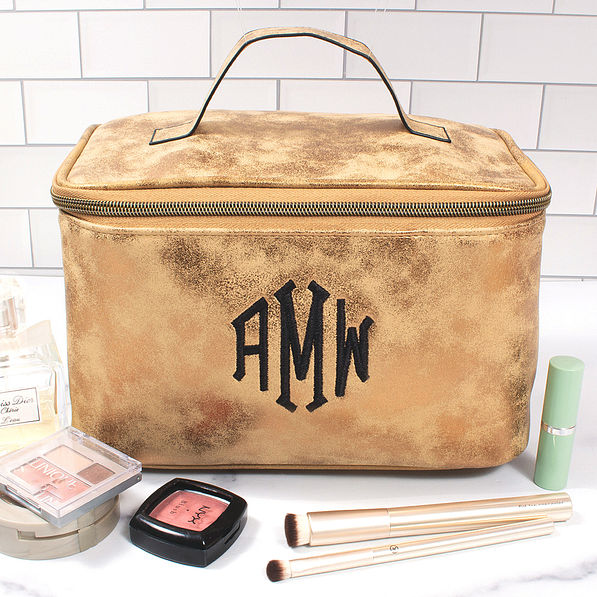 monogrammed distressed metallic train case on bathroom counter