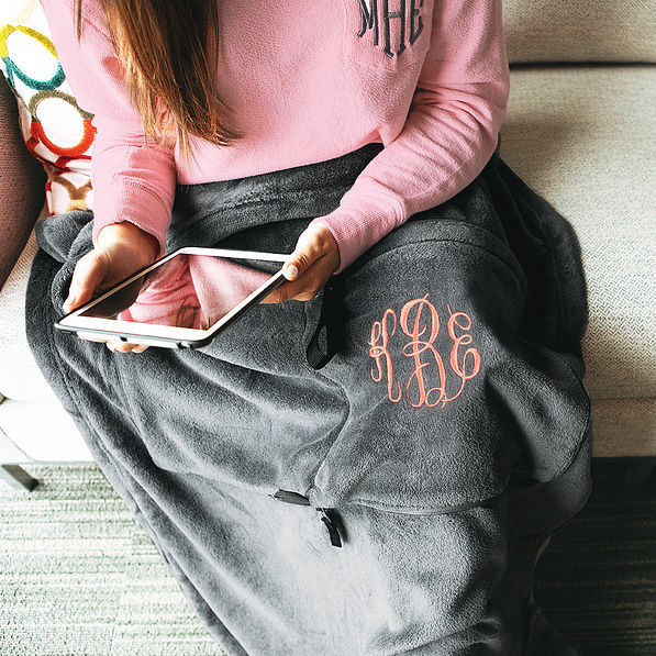 monogrammed travel blanket on sofa
