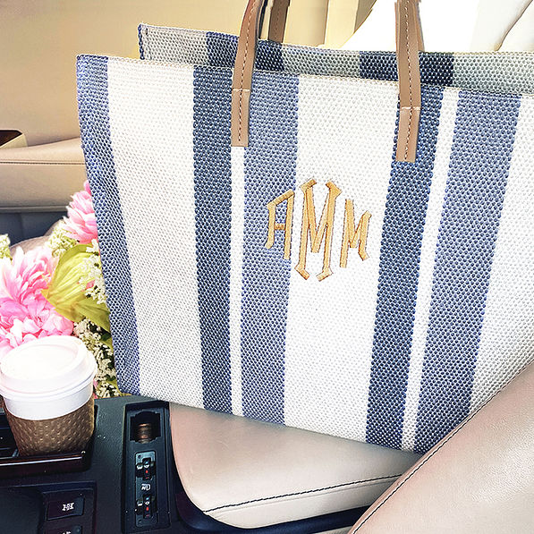 monogrammed striped handbag in car flowers