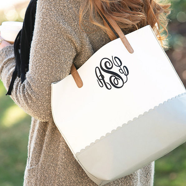 monogrammed scalloped tote bag on shoulder
