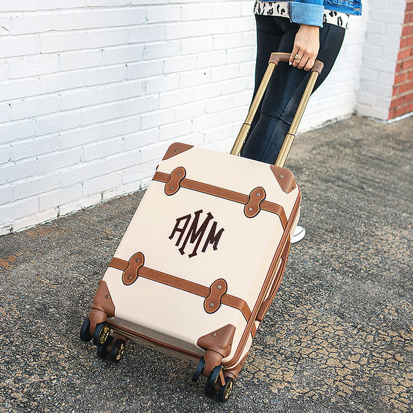 vintage monogrammed carry on luggage being rolled on wheels- NEW