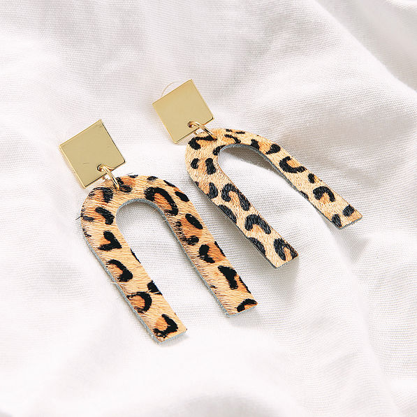 leopard horseshoe earrings on white sheet