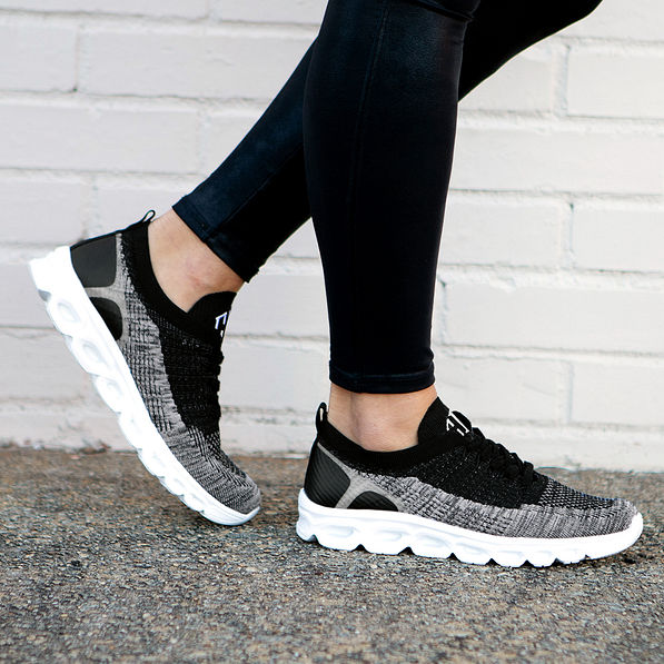 black scallop sneakers on asphalt