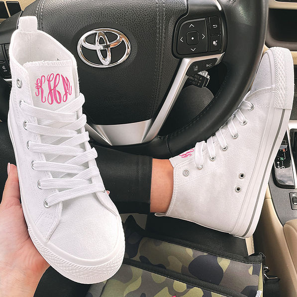 white monogrammed high top sneakers in car