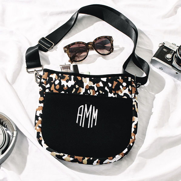 black brown crossbody with sunglasses and camera