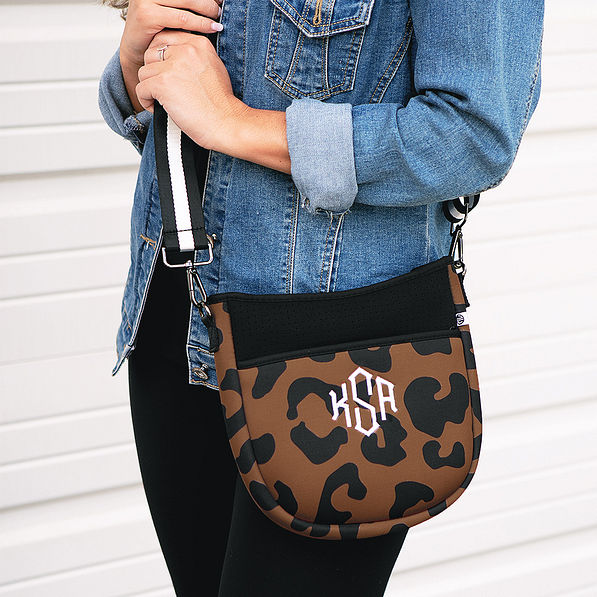 girl wearing hickory leopard crossbody with denim jacket