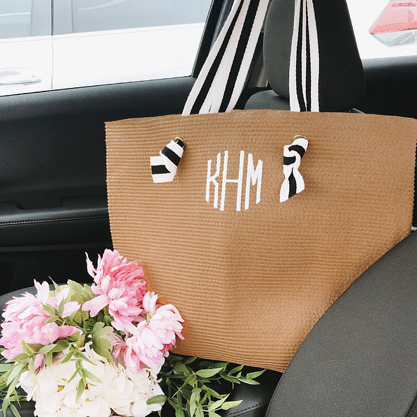 monogrammed straw purse in car