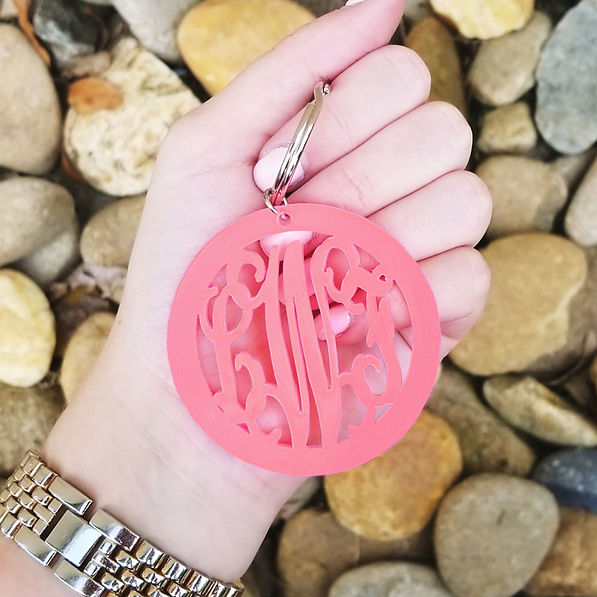 pink acrylic monogrammed keychain in hand