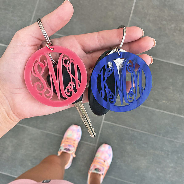 pink and blue acrylic monogrammed keychain in hand