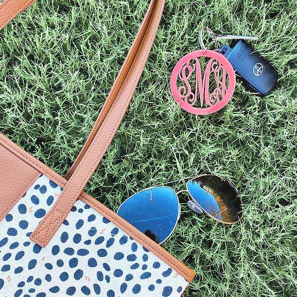 acrylic monogrammed keychain on the grass
