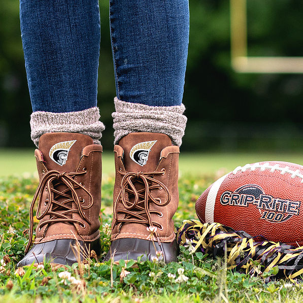 anderson duck boots with brown socks on football field