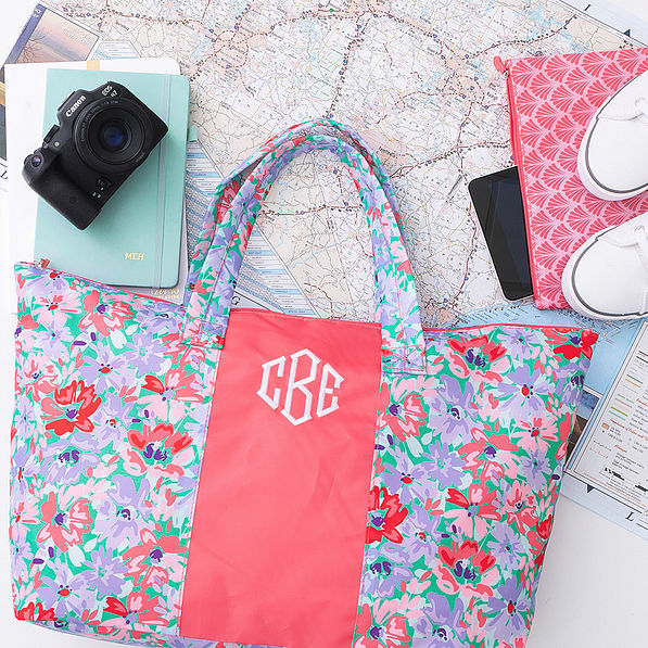 coral botanical packable weekend duffel over map