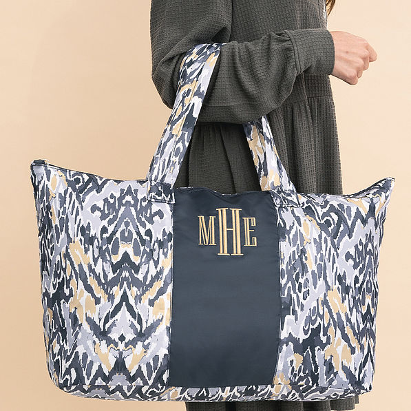 close up of gray ikat monogrammed packable weekend duffle bag