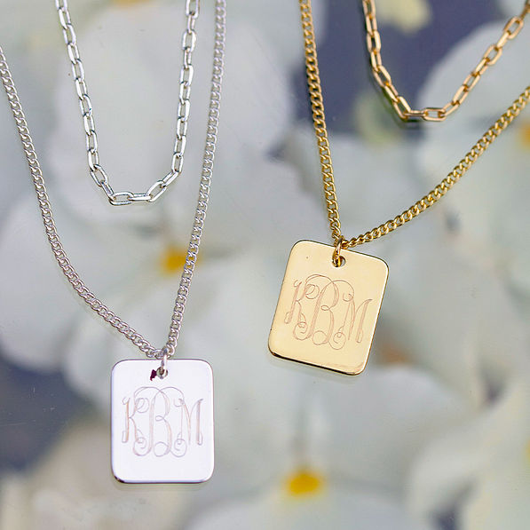 flatlay of layered pendant necklaces - gold and silver