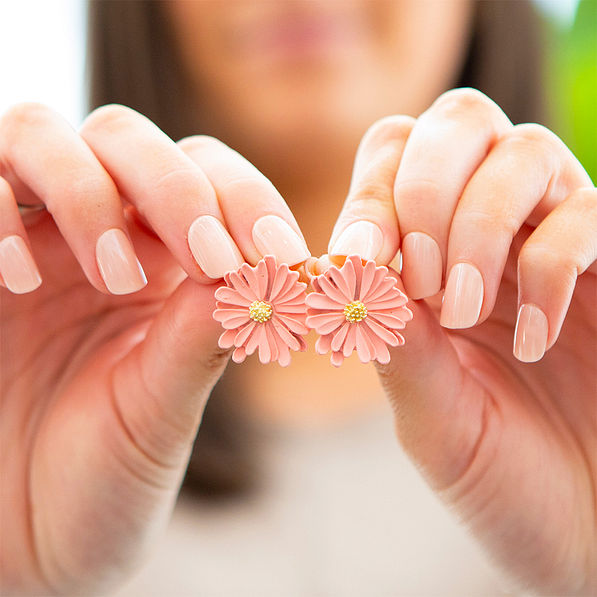 daisy earrings in hands