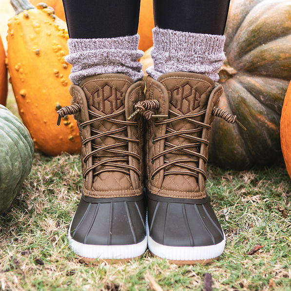 hickory quilted duck boots on feet with pumpkins