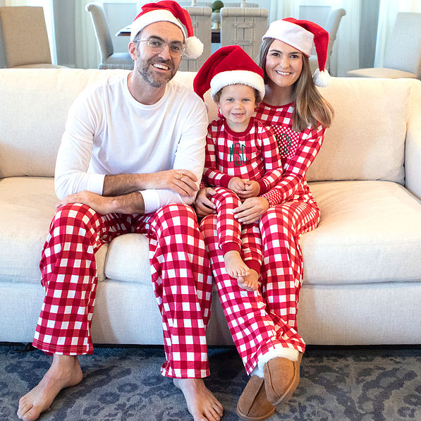 christmas morning family pic on the couch in matching red plaid pajamas