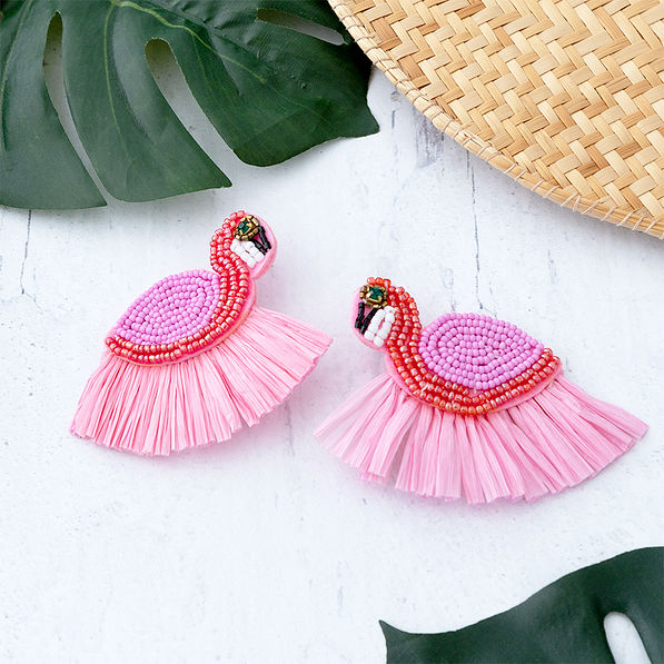 flamingo earrings on table