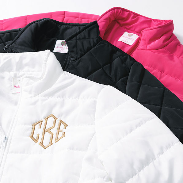 black white and hot pink monogrammed puffer jackets upclose