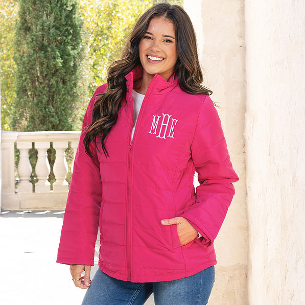 girl wearing monogrammed hot pink puffer jacket up close