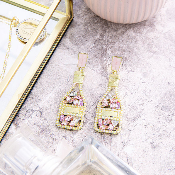 rose all day earrings on marble counter top