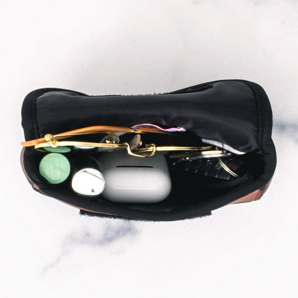 inside of neoprene travel pouch holding items