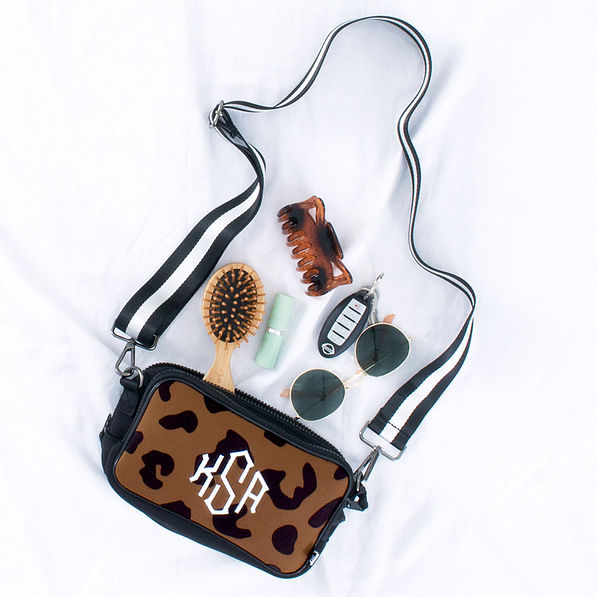 Monogrammed Neoprene Crossbody Camera Bag with contents spilled