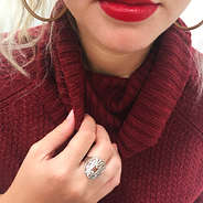 sterling silver cut out ring on hand burgundy turtleneck sweater