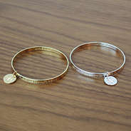 Silver and Gold Inspirational Bracelets on Wood