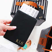 Monogrammed Passport Holders in black with striped luggage and weekender bag