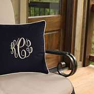 monogrammed navy blue throw pillow in chair