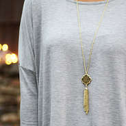 monogram gold tassel quatrefoil necklace gray shirt