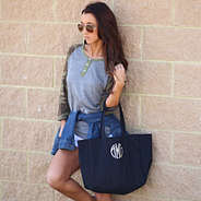 girl wearing camo top with navy tote bag