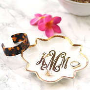 jewelry tray with tortoise bangle and pink flower