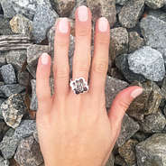 girls hand wearing silver quatrefoil ring