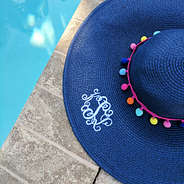 navy straw monogrammed floppy hat with multicolored poms