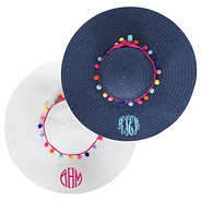 navy and white straw sun hats with monograms and pom poms