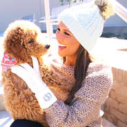 Girl wearing cuffed hat with matching monogrammed gloves in ivory