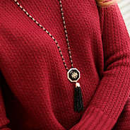 Model Wearing Red Sweater with Tassel Pendant Necklace