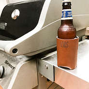 monogrammed brown leather koolie with bottle
