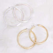 Gold and Silver Featherweight Brushed Hoop Earrings on quartz background