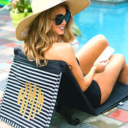 Monogrammed striped mat by the pool