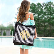 Monogrammed striped beach mat by the pool